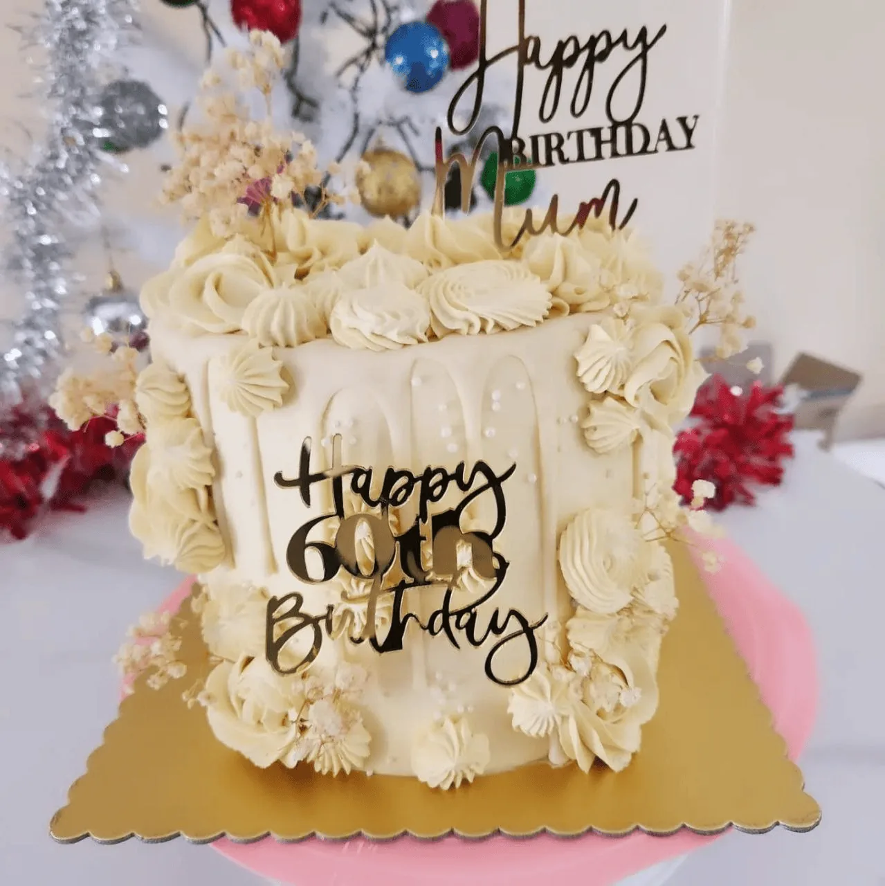 Cream 60th birthday cake with piped floral details