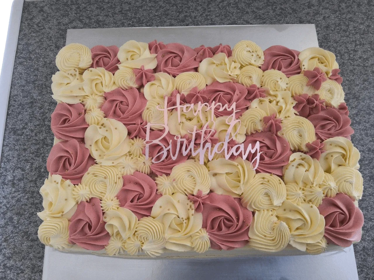 Pink and cream rectangular birthday cake